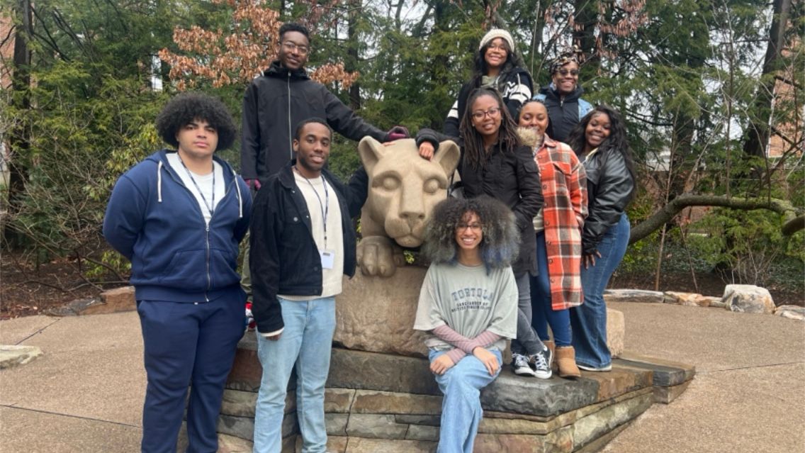 Makira Davis and her cohort of history and political science students in the Catto-LeCount Fellows Program for Equity and Inclusion at Penn State pose in front of the Nittany Lion Shrine.