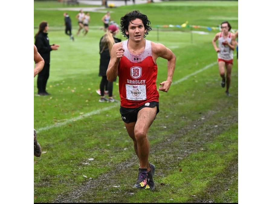 Rodrigo Alvarez Gonzalez running through mud during a cross-country event.