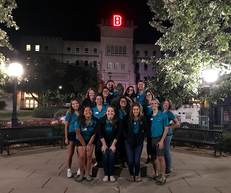 students in front of Bradley Hall at night