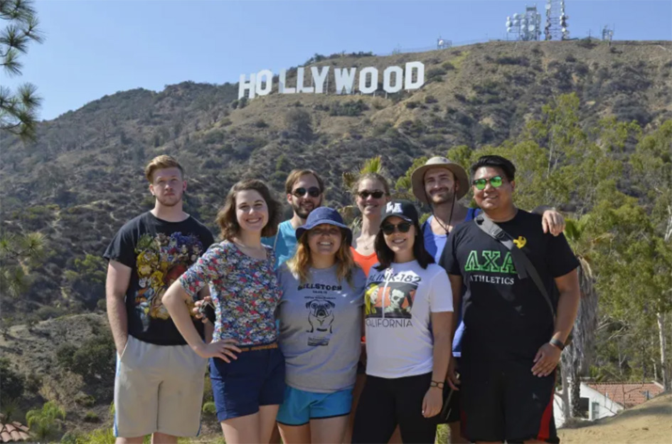 students in front of Hollywood sign