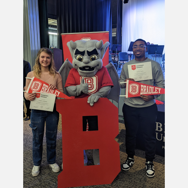 Richwoods High School seniors Kaizon Davis (psychology) and Amber Lempesis – (chemical engineering-chemistry) receive their Hometown Scholar awards from Bradley University at a surprise ceremony in the school auditorium.