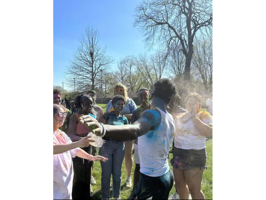 Students coat each other in colorful powder as they celebrate Holi on campus, as organized by the Indian Student Association