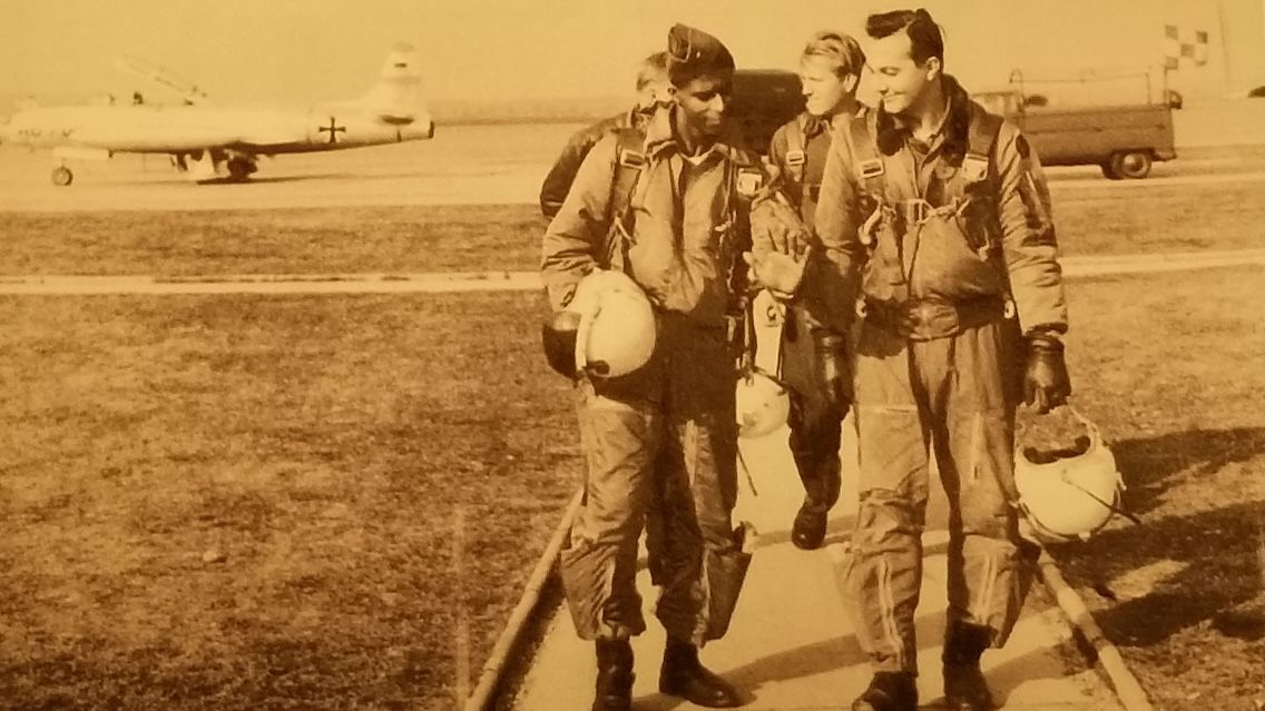 Robert Henry Lawrence Jr. and his colleagues in the Air Force walk away from the tarmac with a plane in the background