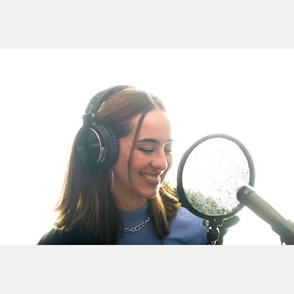 Adriana Dunn smiling in front of a microphone