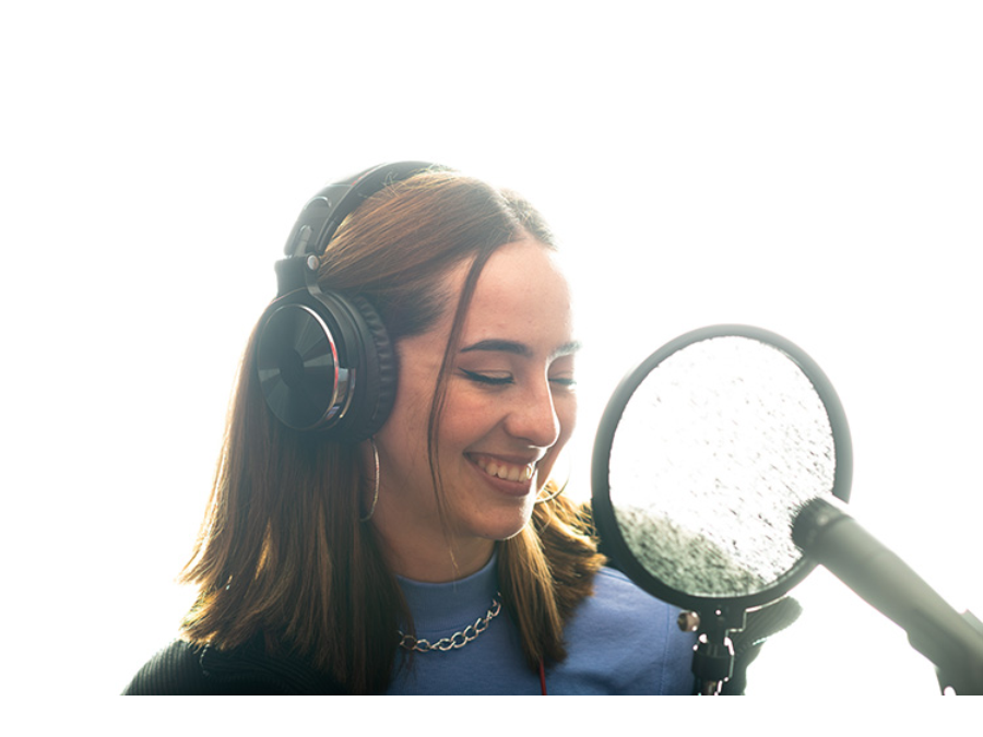 Adriana Dunn smiling in front of a microphone