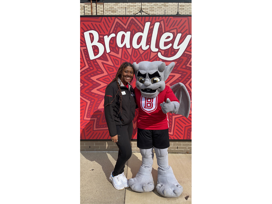 Photo of Kamia Berry with Bradley University's mascot KABOOM