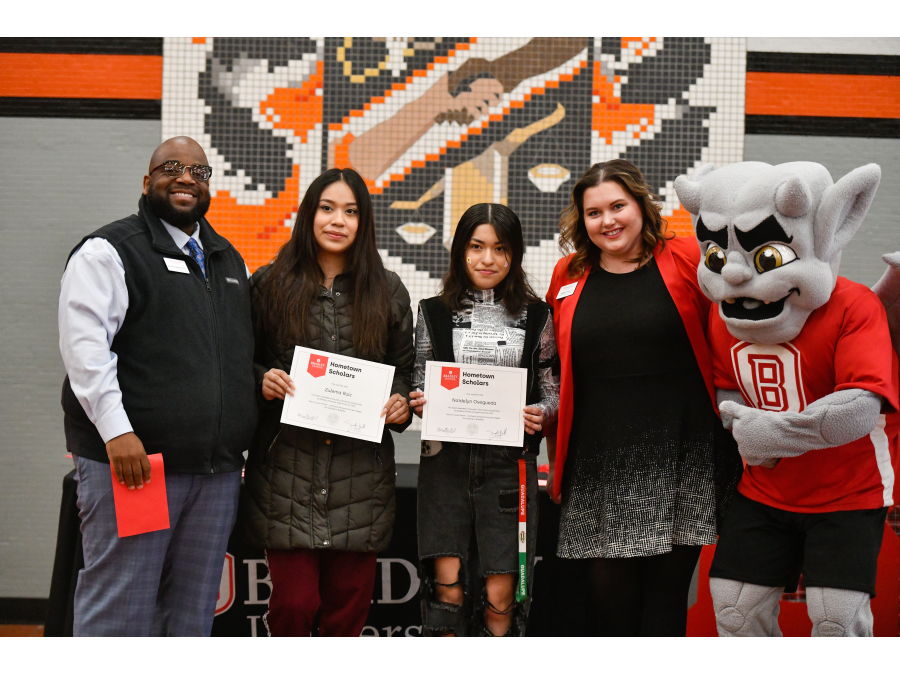 Manual High School students Naidelyn Osegueda (entrepreneurship) and Zulema Ruiz (civil engineering) receive their Hometown Scholar awards from Bradley University in a surprise presentation at Manual.