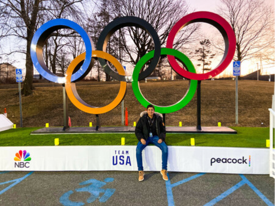 Francisco Alonzo sitting under Olympic rings.