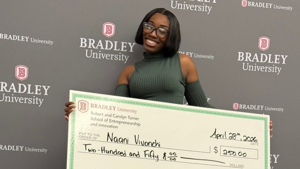 Sanaa Parker poses with a giant check for her beauty venture, Naani Vivonchi.