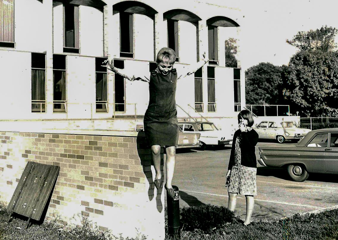Woman jumping off ledge