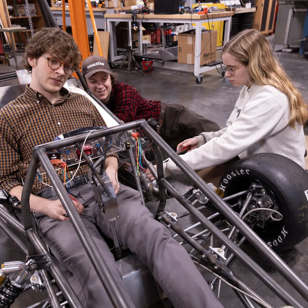 Students working on a formula 1 vehicle