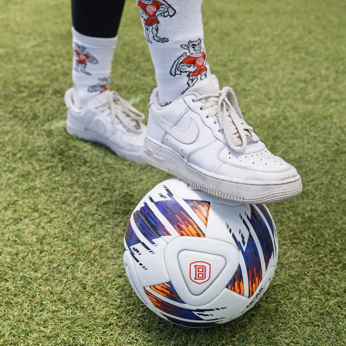 A closeup of a woman's foot on a soccer ball