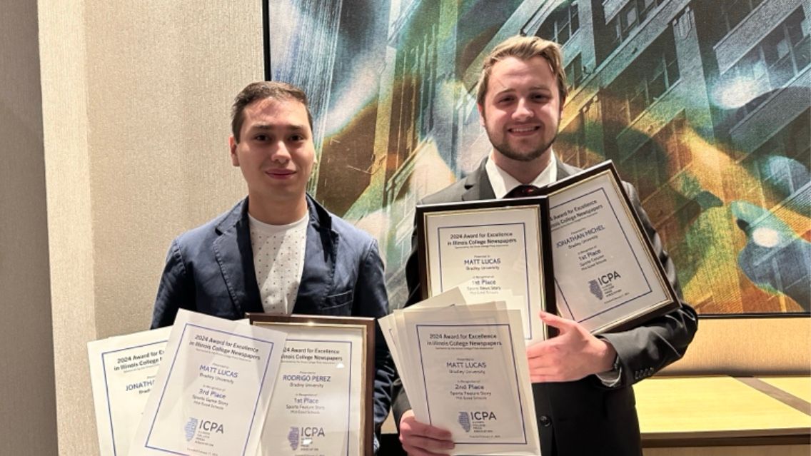 Senior sports communication majors and The Scout editors Rodrigo Perez (left) and Mason Klemm (right) pose with some of the 24 awards won by Bradley’s student newspaper at the Illinois Press College Association annual conference.