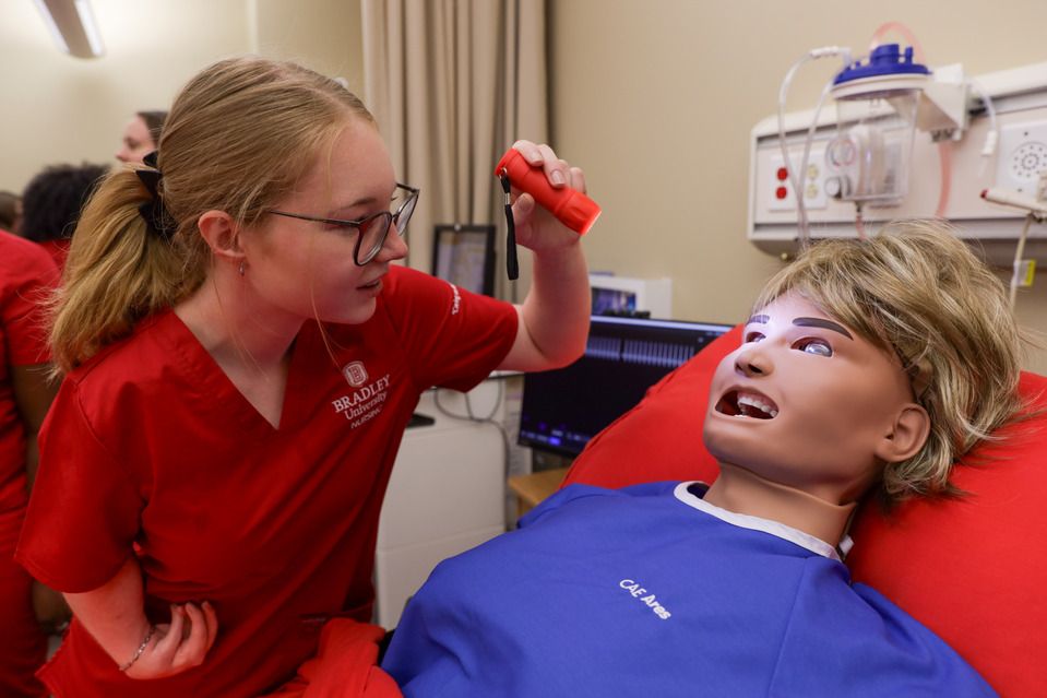A Bradley nursing student uses the new simulation lab, which includes high-fidelity manikins.